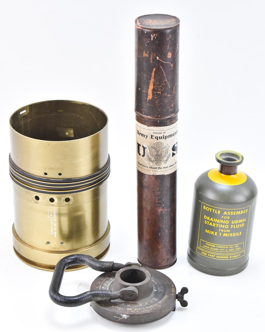 MILITARIA ASSORTMENT: An assortment of militaria items including a 155mm rocket shell, a document tube with a glued on cutout from a Henry V. Allien & Company advertisement, a bottle assembly for draining a Nike 1