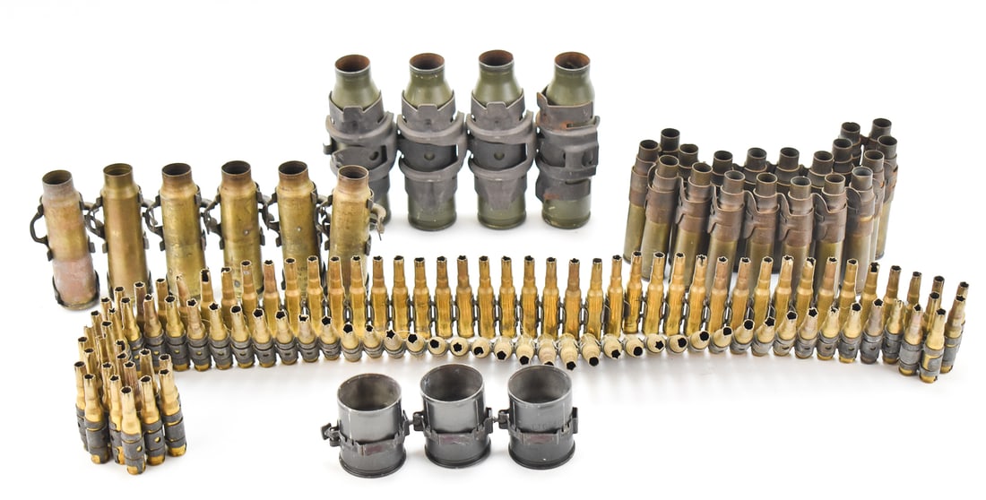 ASSORTMENT OF SPENT SHELLS W/ LINKS: An assortment of various spent belt-fed shells with links including 7.62mm rounds for the M60 machine gun, 7.62x51 rounds for the M30 machine gun, 20mm rounds for the M103, four 25mm rounds for the