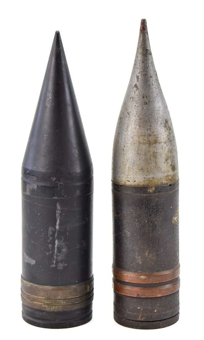 PAIR OF 90MM ARMOR-PIERCING M318A1 PROJECTILES: A pair of 90mm armor-piercing M318A1 projectiles from the Vietnam War era. Each projectile measures approximately 15" H x 3.5" W x 3.5" D.