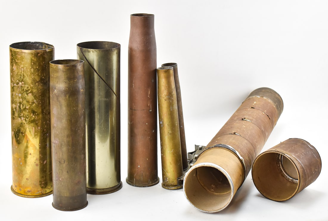 ASSORTMENT OF MILITARY INERT SHELLS & STORAGE TUBE: An assortment of inert military shells and a Howitzer shell storage tube. The shells include a 105mm M14 from 1953, a 105mm M14B4 from 1973, a 57mm M1 shell from 1945, a 75mm shell, and two 40mm US