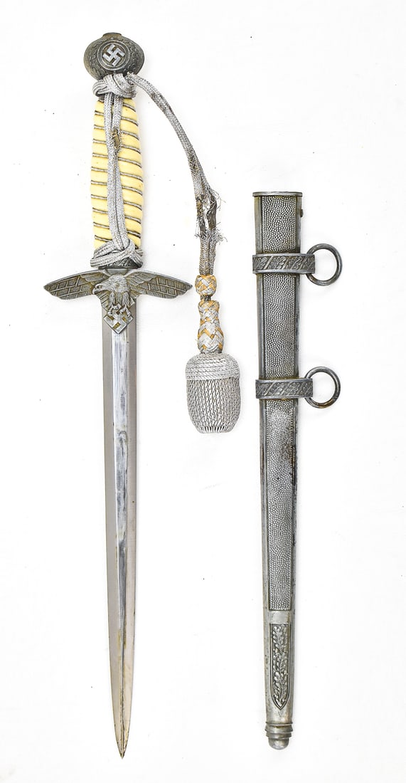 WEYERSBERG KIRSCHBAUM & CIE WWII GERMAN LUFTWAFFE SECOND PATTERN DAGGER: A Weyersberg Kirschbaum & Cie (WKC) Solingen World War II German Luftwaffe double-edged dagger (blade length: 10") in the second pattern with a honey color grip, scabbard, and portepee. The item