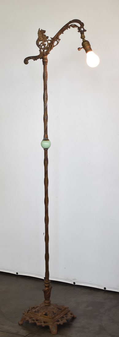 REMBRANDT TUDOR REVIVAL GILT PAINTED CAST IRON GRIFFIN BRIDGE LAMP: A Rembrandt Tudor Revival gilt painted griffin cast iron bridge lamp with a peened base and uranium glass segment, circa 1920s. The item measures 60" H, 13" W, 12" D.