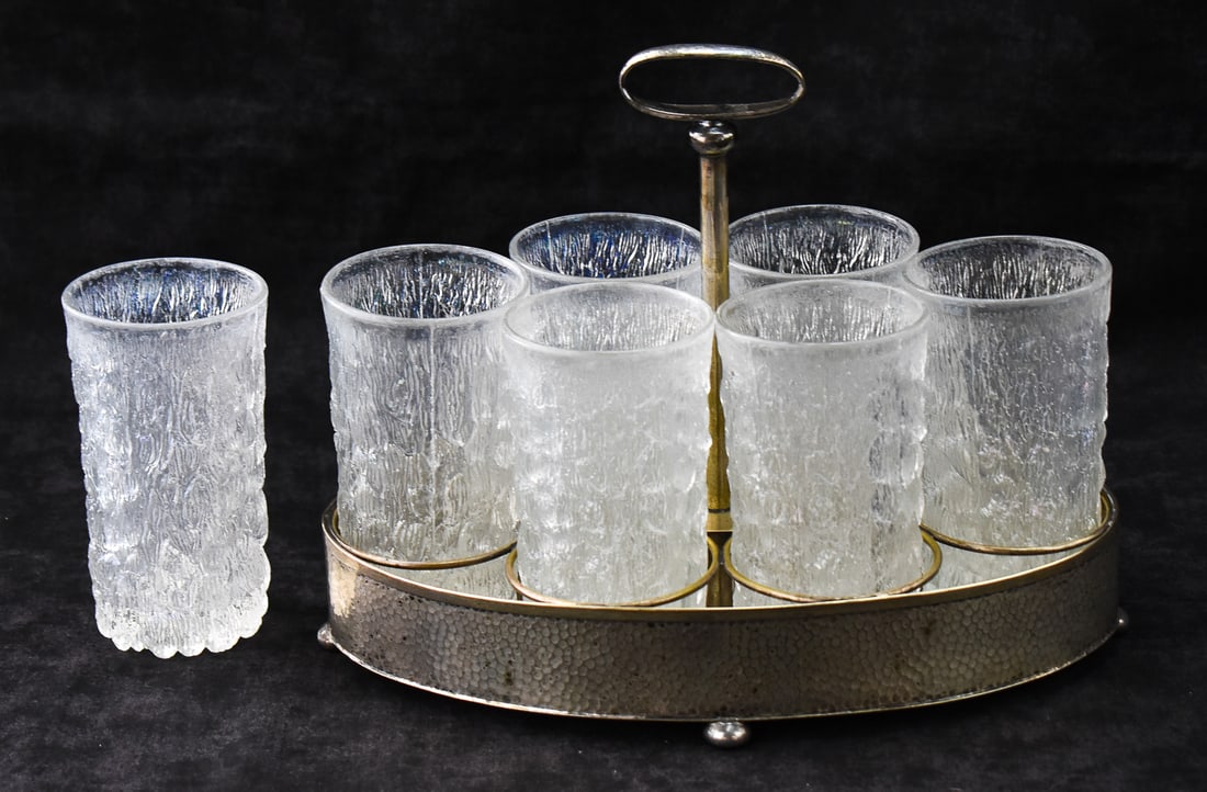 TABER & TIBBITS BOTTLE TRAY & GOEBEL "ICE BARK" GLASS TUMBLERS: A Taber & Tibbits hammered silver bottle tray circa early 20th century with seven Goebel Italian marked "Ice Bark" pattern glass tumblers circa mid 20th century. The largest item measures 9" H, 11.5"