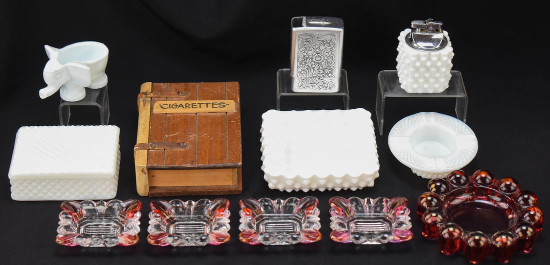 20TH CENTURY GLASS TOBACCIANA ASSORTMENT: WESTMORELAND, FENTON, & MORE: This lot includes a Westmoreland Glass Company milk glass "Diamond Point" hat ashtray, Westmoreland Glass Company (attributed) four-piece ruby flash ashtray set, Westmoreland (attributed) milk glass "