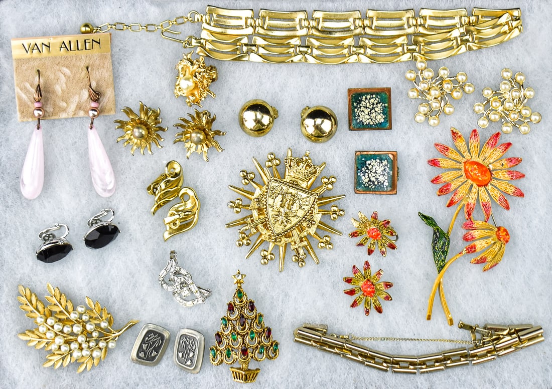 SIGNED DESIGNER COSTUME JEWELRY: TRIFARI, MONET, CORO, & MORE: An assortment of signed designer costume jewelry brooches, earrings, a bracelet, and a necklace. All of the pieces are signed by costume jewelry makers including Trifari, Napier, Coro, Matisse, Hollyc