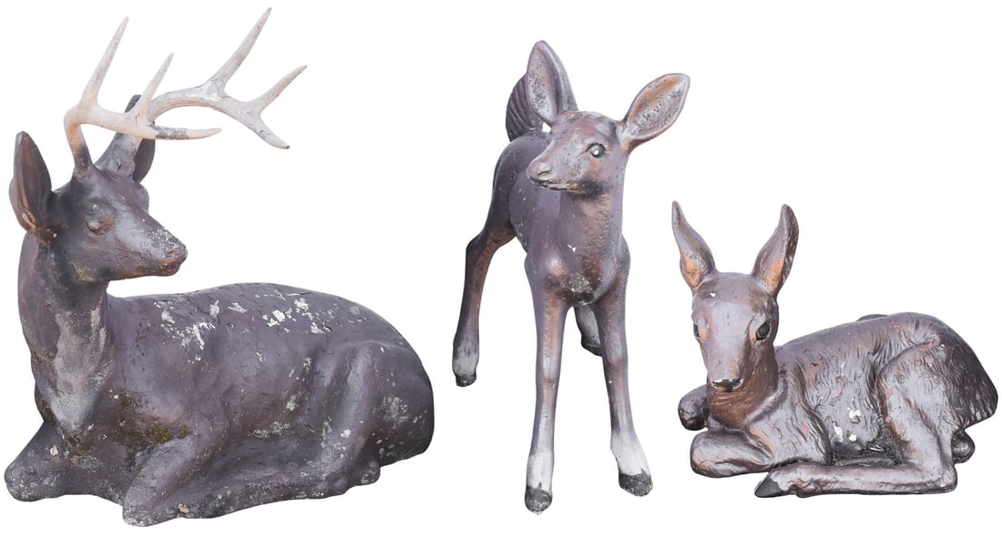 TRIO OF VINTAGE CONCRETE DEER GARDEN SCULPTURES: A trio of painted concrete deer garden sculptures, circa early 20th century. The buck measures 27.5" H x 26.5" W x 17" D.
