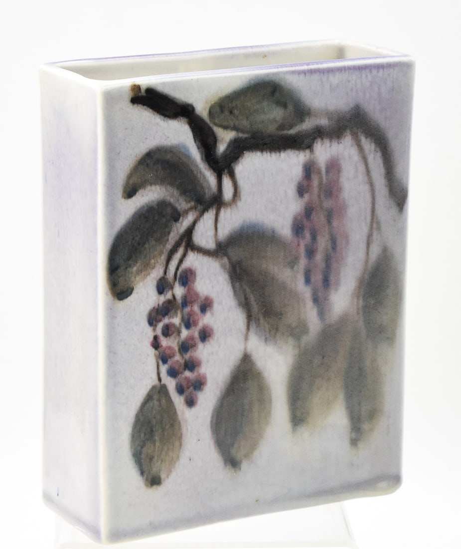 ROOKWOOD JENS JENSEN MARKED GRAPE PATTERN PILLOW VASE: A Rookwood marked grape pattern pillow vase No. 62926 by artist Jens Jensen, date code appears to read "XLVI" (1940). The item measures 7.5" H, 6" W, 2.5" D.