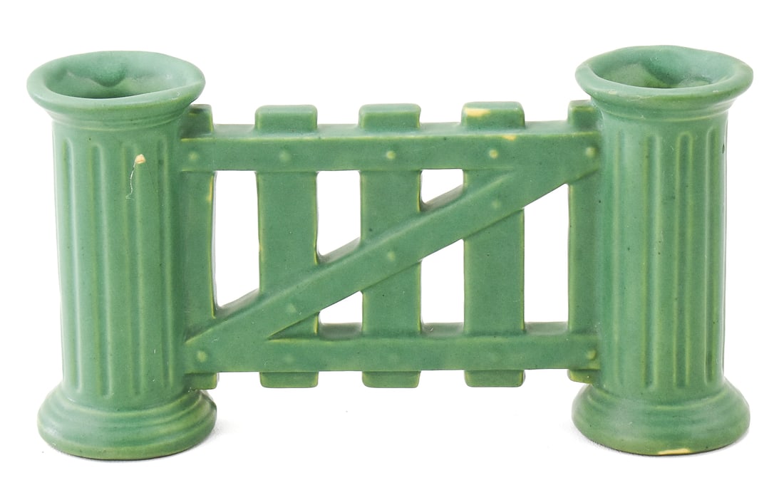 ROSEVILLE MATTE GREEN GATED DOUBLE BUD VASE No. 7: A Roseville matte green gated double bud vase incised with No. 7, circa 1905-1916. The item measures 4.5" H, 8.5" W, 2" D.