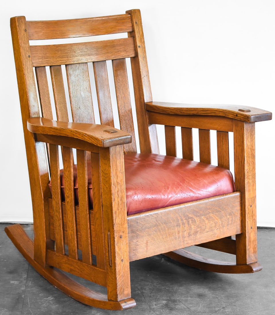 HARDEN COMPANY WAVY ARM MISSION OAK ARTS AND CRAFTS ROCKER, C. EARLY 20TH CENTURY: A Harden Company of Camden, NY Mission oak Arts and Crafts wavy arm rocker circa early 20th century. The rocker features quarter-sawn oak planks and a red leather cushion. The rocker measures 38" H x 