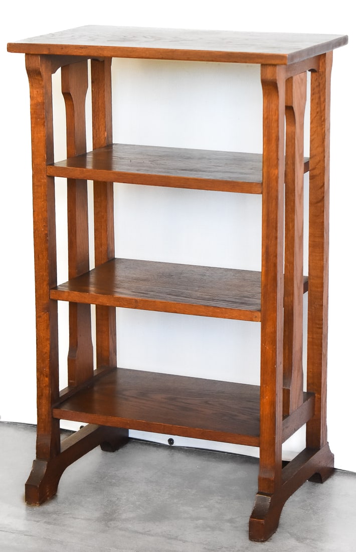ARTS AND CRAFTS STYLE OAK OPEN BOOKCASE: An Arts and Crafts style oak open bookcase with three shelves, circa early 20th century. The item measures 34" H, 21" W, 13" D.