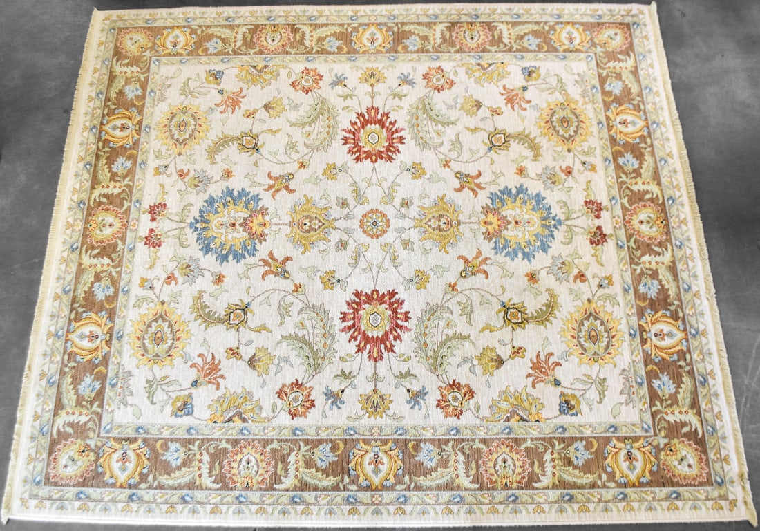 KARASTAN SOVEREIGN "ANASTASIA" PATTERN WOOL RUG: A Karastan Sovereign 100% wool rug in the "Anastasia" pattern with a traditional floral design in the field and ivory and tan colors. The rug measures 122" H x 105" W x 0.5" D.
