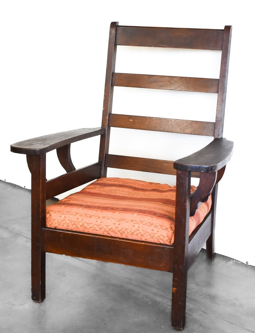 BARBER BROTHERS BOWED-ARM OVERSIZED MORRIS STYLE CHAIR: A Barber Brothers bowed-arm oversized Morris style dark stained wood chair, circa early 1900s. The item measures 42" H x 33" W x 28" D.