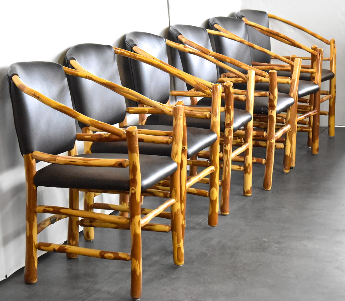 SET OF SIX OLD HICKORY TWO-HOOP ARMCHAIRS: A set of six Old Hickory two-hoop armchairs with black leather seats and backs; made in Shelbyville, IN. The items measure 33" H x 26" W x 26" D.