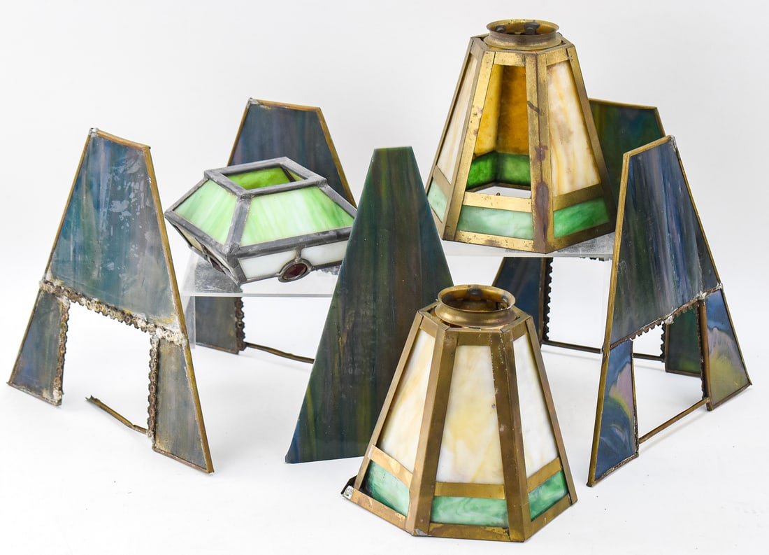 SLAG GLASS LAMP SHADES, CIRCA EARLY 20TH CENTURY: This lot includes one slag glass lamp shade with jeweled accents, slag glass and brass lamp shade pair, and one floral-rim blue slag glass lamp shade, circa early 20th century. The largest item measur