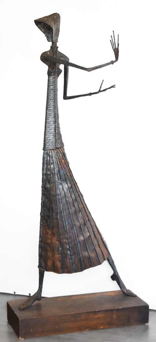 SIGNED BRUTALIST STYLE FLOOR-STANDING WOMAN SCULPTURE: A Brutalist style floor-standing metal woman sculpture signed "WT", circa mid-late 20th century. The item measures 64.5" H, 28" W, 18" D.