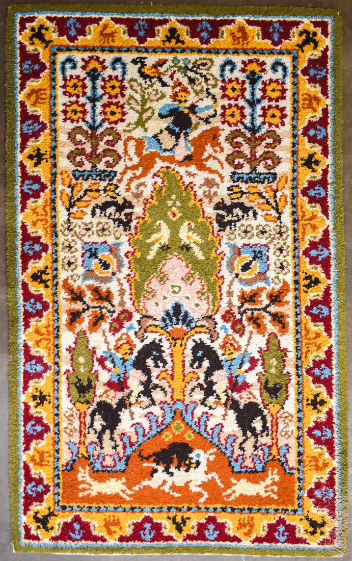 KASHMIR WOOL HAND-KNOTTED TREE OF LIFE RUG: A Kashmir wool hand-knotted rug depicting a Tree of Life design. The rug features bright colors and figural, floral, and animal motifs. The rug measures 75" L x 46" W x 0.5" D.