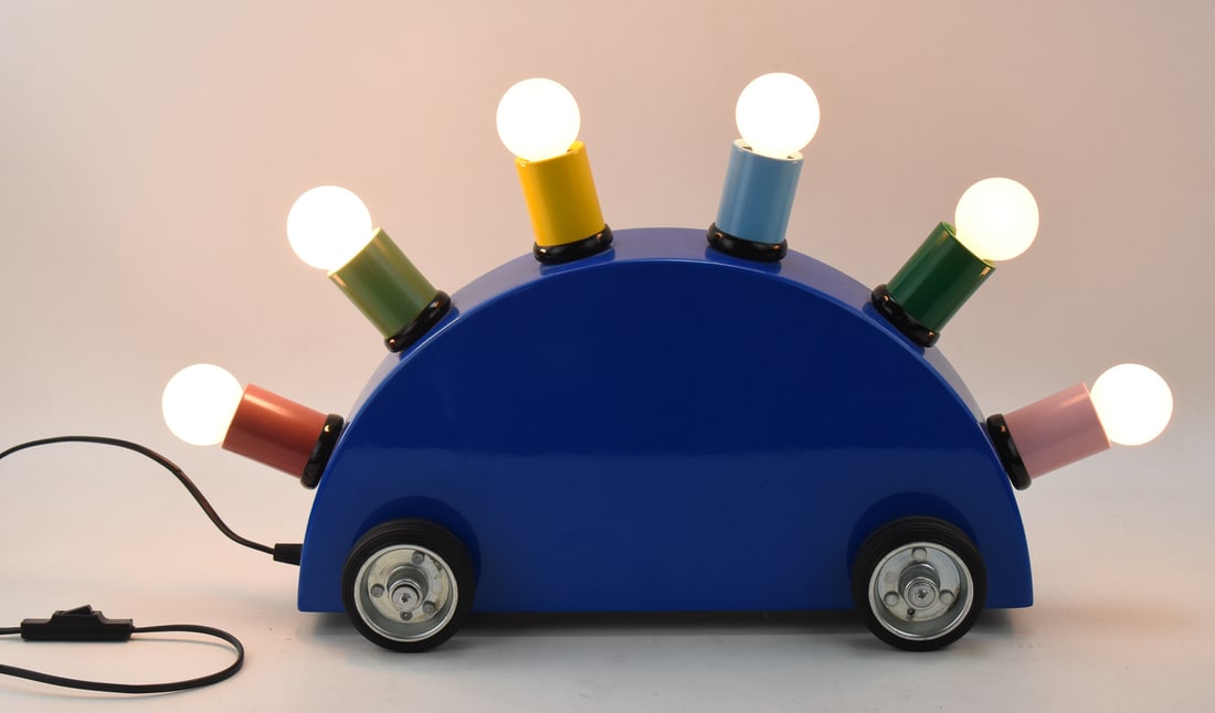 1981 MARTINE BEDIN FOR MEMPHIS GROUP "SUPER LAMP": A 1981 Martine Bedin for the Memphis Group, Milano "Super Lamp" in a car-form with maker's label. The item measures 13.5" H, 24" W, 7" D.