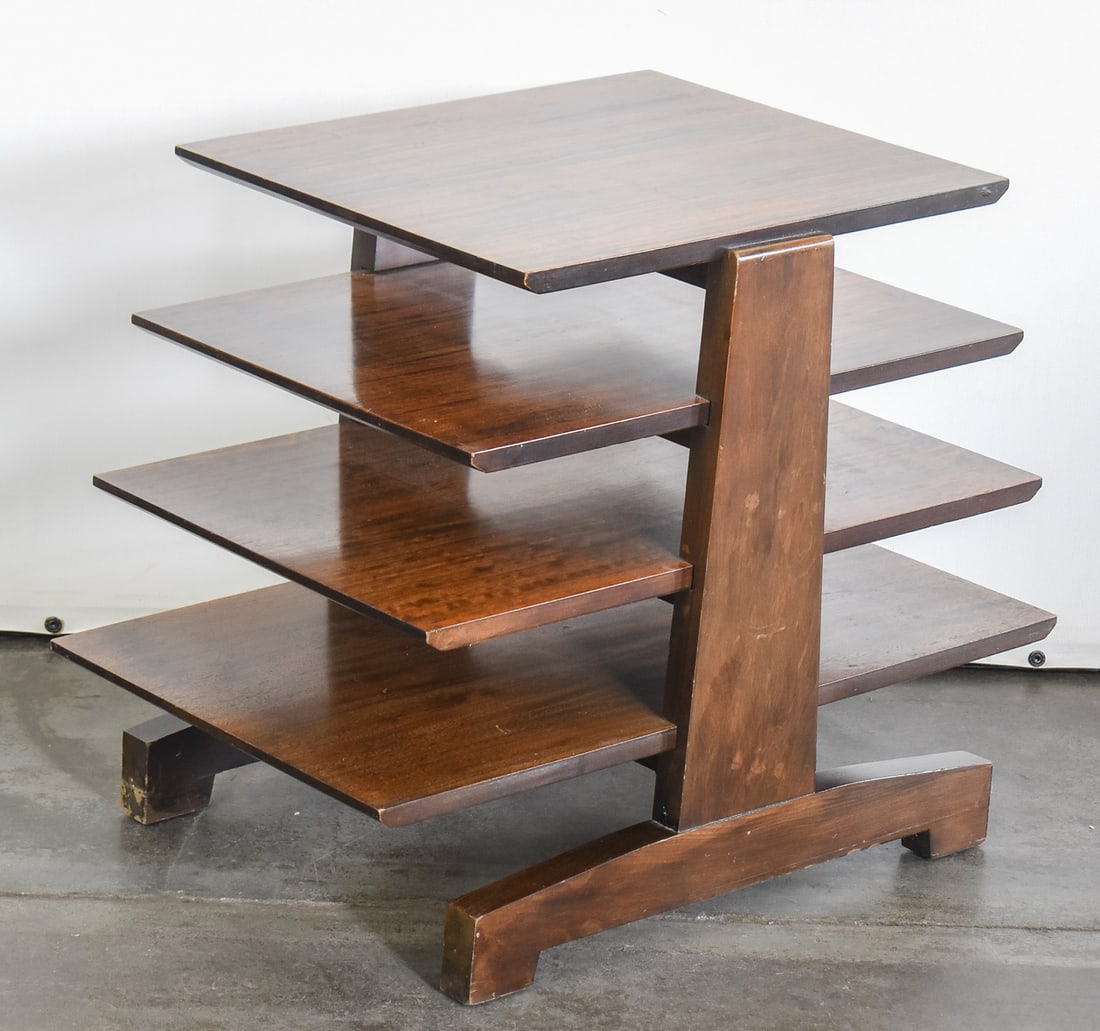 MID-CENTURY FOUR-TIERED WOOD MAGAZINE TREE IN THE MANNER OF DREXEL: A Mid-century four-tiered wood magazine tree in the manner of Milo Baughman for Drexel. The item measures 21" H x 26" W x 18" D.