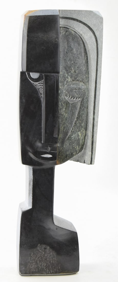 SIGNED AFRICAN SHONA ABSTRACT STONE SCULPTURAL BUST: A signed African Shona abstract stone sculptural bust. The item measures 22" H, 6.5" W, 3" D.