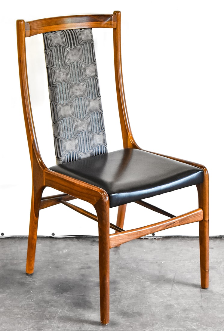MID-CENTURY MODERN SCULPTED WALNUT DINING CHAIR: A Mid-century Modern sculpted walnut dining chair that appears to have been reupholstered with a black vinyl seat and an abstract fabric back. The chair measures 36" H x 18.5" W x 17" D
