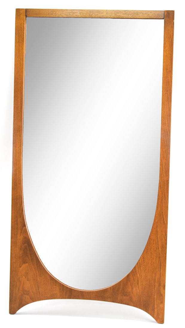 BROYHILL FURNITURE MID-CENTURY MODERN 'BRASILIA' WALNUT WALL MIRROR: A Broyhill Furniture Mid-century Modern "Brasilia" walnut wall mirror, circa mid 20th century. The item measures 42" H, 21.5" W, 1.5" D.