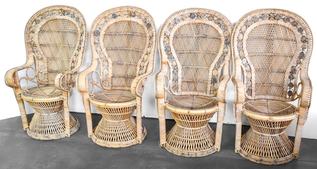 SET OF VINTAGE RATTAN CHAIRS: Four peacock rattan chairs featuring a high flared back. Each chair measures 54" H x 38" W x 24" D.
