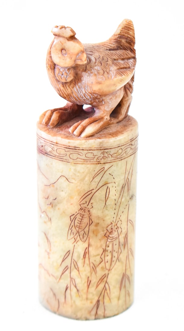 CHINESE SOAPSTONE ROOSTER SEAL STAMP: A Chinese carved soapstone seal stamp with a carving of a rooster on the top, circa 20th century. The outside of the stamp has images of the Chinese landscape and carvings of beetles. The base of the