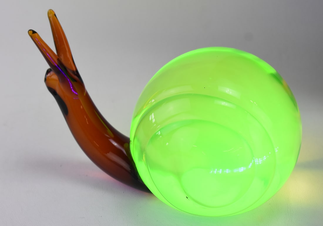 MURANO URANIUM GLASS SNAIL: A Murano uranium glass snail with a sticker label; possibly by Luciano Gaspari for Salviati. The item measures 5" H, 7.5" W, 5" D.