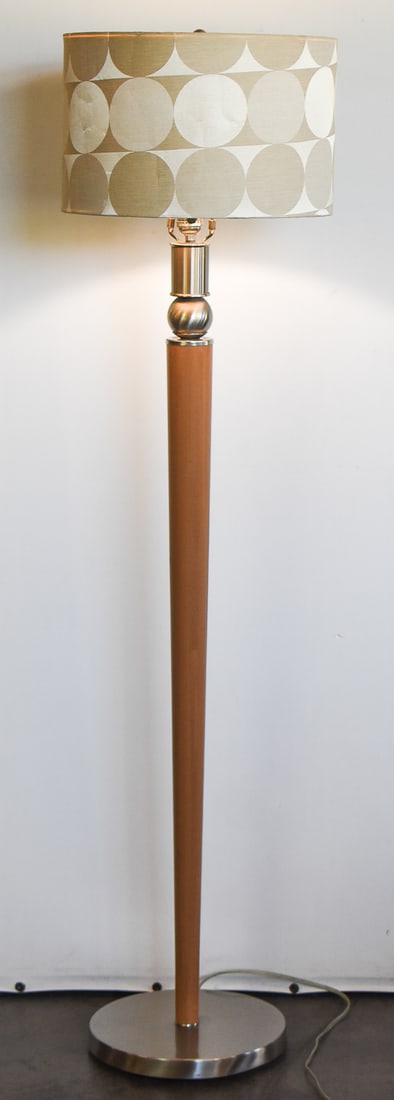 MID-CENTURY STYLE CHROME FLOOR LAMP: A contemporary Mid-century style wood and brushed chrome floor lamp. The item measures 55" H x 14" W x14" D.