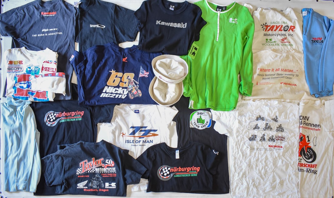 COLLECTION OF VINTAGE ADVERTISING T-SHIRTS & MORE: A collection of vintage and newer advertising t-shirts, and two 1980 Honda sailor-style caps all from Taylor Motorcycles of Woodburn, Oregon that was open from 1964-2020.