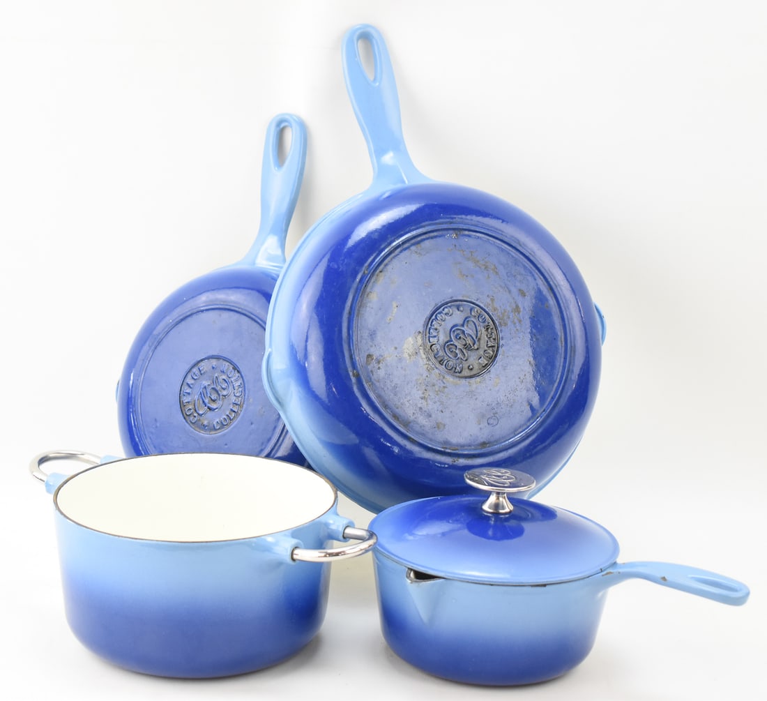 FOUR COTTAGE COLLECTION CAST IRON ENAMEL PIECES: This lot includes four Cottage Collection cast iron enamel pieces: dutch oven, lidded pot, sauce pan, and skillet. The largest item measures 5" H, 13.5" W, 9" D.