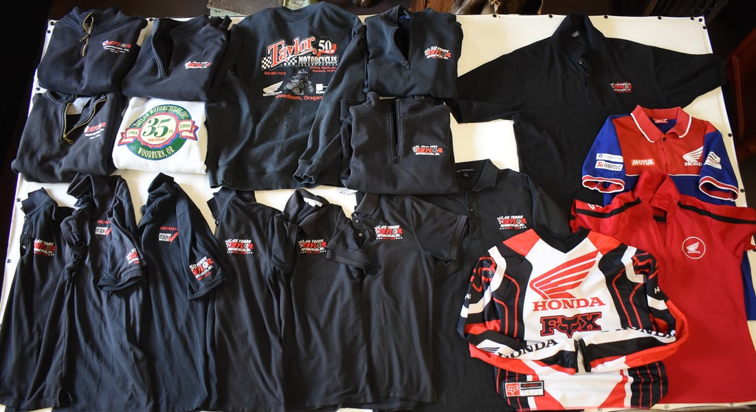 COLLECTION OF ADVERTISING POLOS & SWEATSHIRTS: A collection of vintage and newer advertising polos and sweatshirts from Taylor Motorcycles of Woodburn, Oregon that was open from 1964-2020.