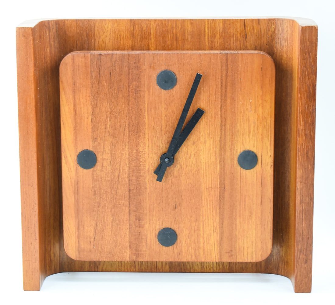 DANISH TEAK MID-CENTURY MODERN WALL CLOCK: A Mid-century Modern teak wall clock made in Denmark. The clock has a minimalist face and a quartz battery operated movement. The clock has a burned in makers mark on the back and the words "MADE IN