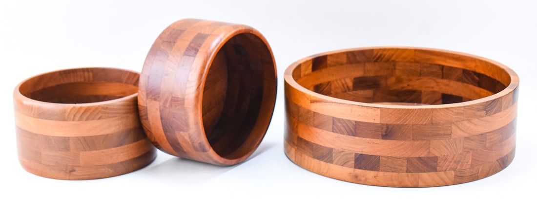 TRIO OF MID-CENTURY KJENI SEGMENTED DANISH TEAK SERVING BOWLS: A trio of Kjeni segmented Danish teak serving bowls, circa 1960s. The largest of the three measures 4.5" H x 13.5" W x 13.5" D.