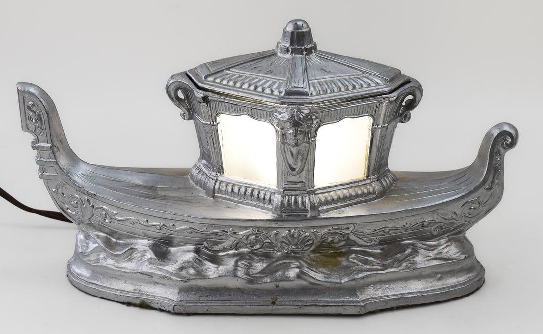 MAJESTIC LAMP WORKS STYLE FIGURAL GONDOLA TV LAMP: A Majestic Lamp Works style figural metal gondola tv lamp with glass inserts, circa early 20th century. The item measures 8" H, 14" W, 5" D.