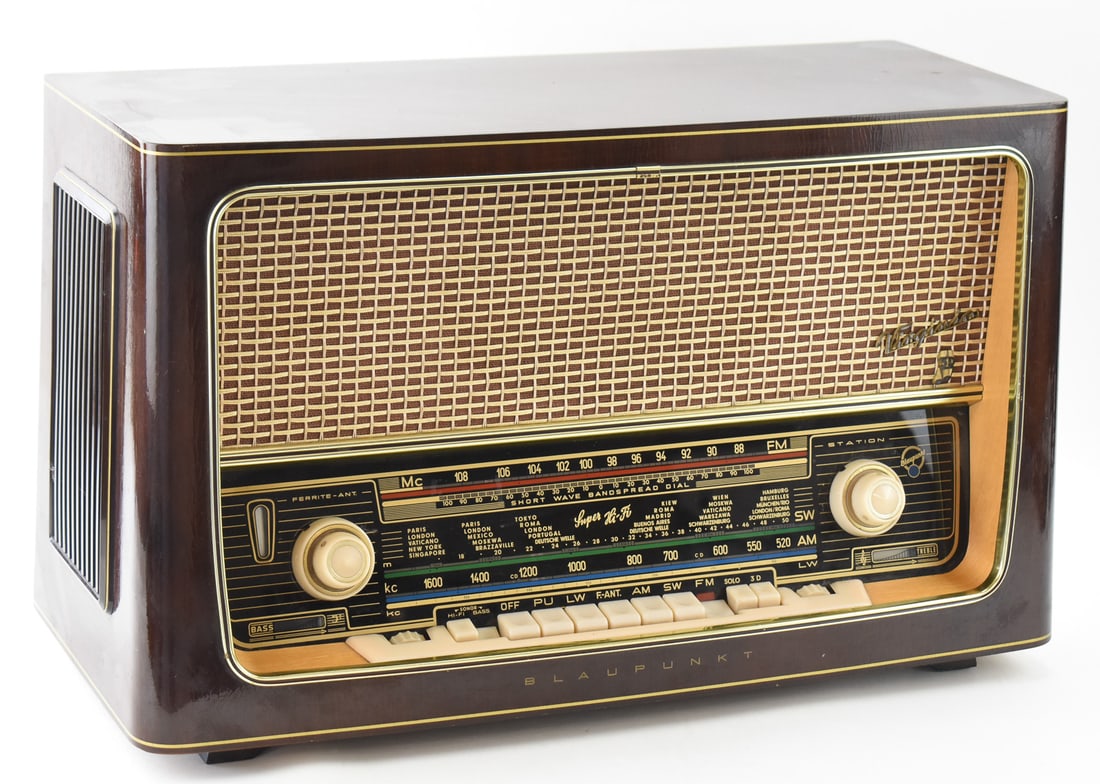 BLAUPUNKT VIRGINIA TYPE 2530 RADIO: A Blaupunkt Virginia Type 2530 Super Hi-Fi 7 tube radio made in Germany circa 1958. The radio has an AM/FM/SW receiver and is housed in a wooden case. The radio measures 14" H x 24" W x 10" D.