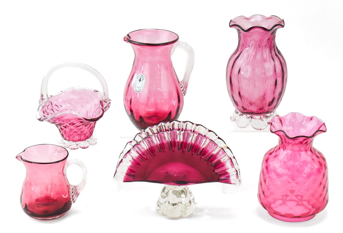 CRANBERRY GLASS ASSORTMENT, PILGRIM GLASS, MURANO: An assortment of six pieces of cranberry glass: Three made by Pilgrim Glass including a small pitcher, medium pitcher with a Pilgrim Glass sticker, floral designed vase, Murano glass small bride's bas