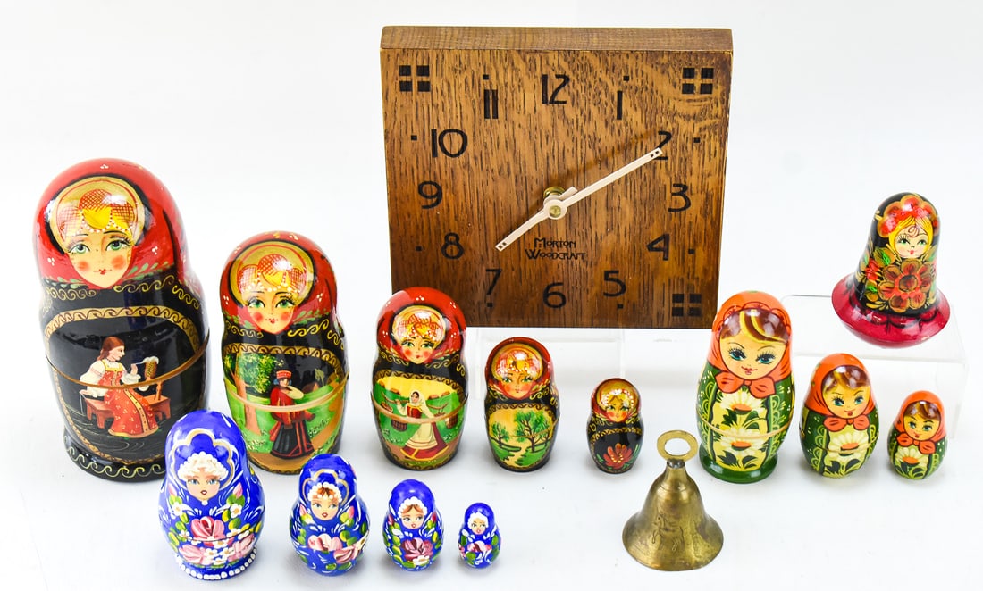 MORTON WOODCRAFT CLOCK, RUSSIAN LAQUER NESTING DOLLS, & BRASS BELL: A Morton Woodcraft Arts and Crafts style woodblock clock made in West Bend, Wisconsin, three Russian lacquered nesting dolls, small Russian lacquered doll with an internal bell, and a small brass bell