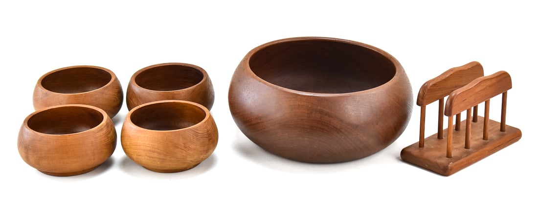 GOODWOOD TEAK MID-CENTURY MODERN BOWLS AND NAPKIN HOLDER: This lot includes the following Goodwood teak Mid-century Modern style items, circa mid-late 20th century: two serving bowls, four individual bowls, and a napkin holder. The largest item measures 5"