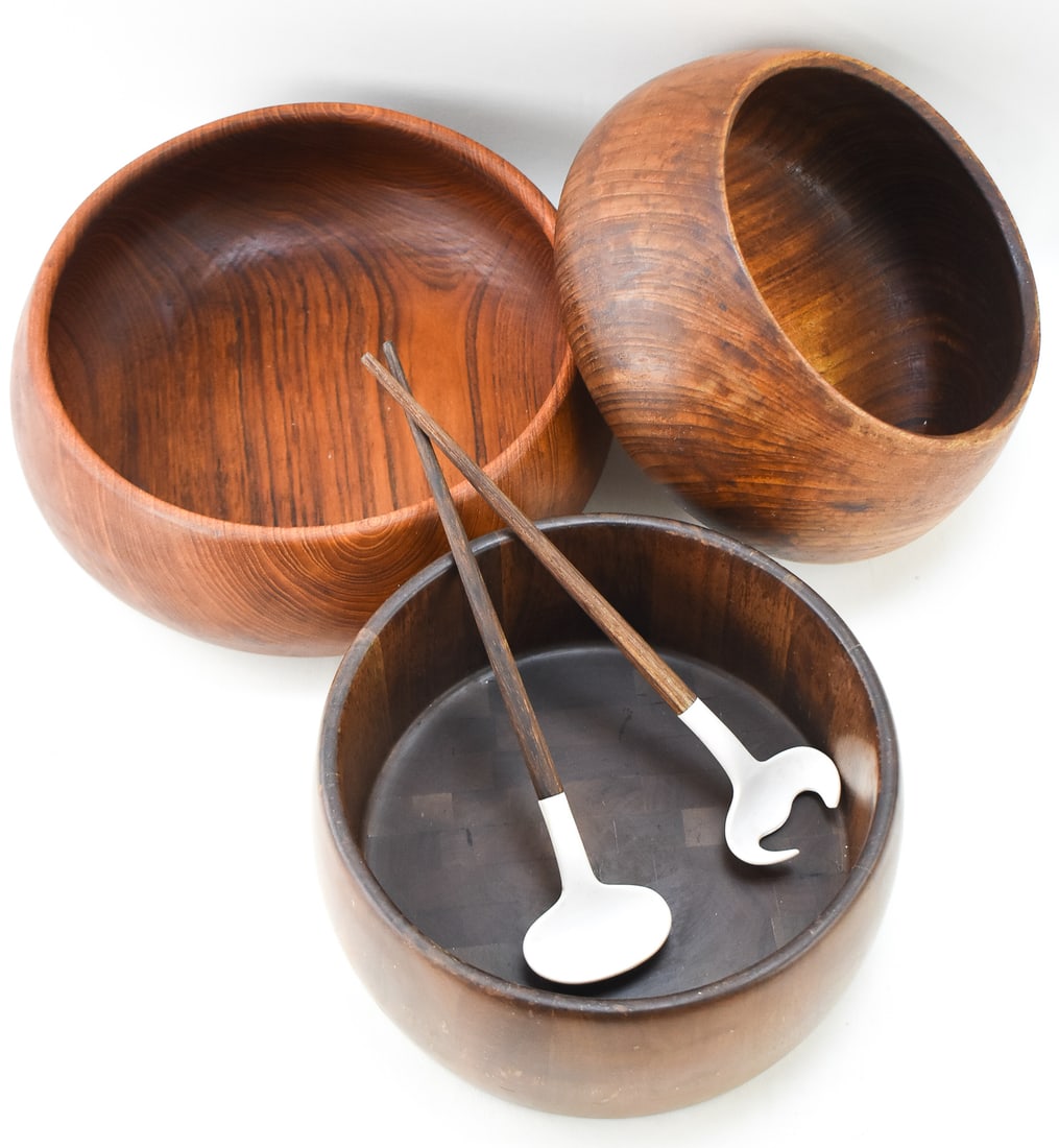 TEAK AND WALNUT SERVING BOWLS: Two teak serving bowls and one staved walnut serving bowl with serving utensils, circa mid-late 20th century. The walnut bowl measures 4.5" H x 12" diameter. There are no makers marks on any of these.