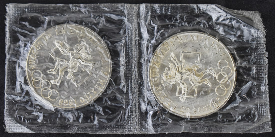 PAIR OF UNCIRCULATED 1968 MEXICO 25 PESO COINS .720 SILVER: A pair of uncirculated 1968 Olympics Mexico 25 Peso coins, each minted in .720 silver with a weight of 0.5208 troy ounces. Both coins are still in the original mint packaging.