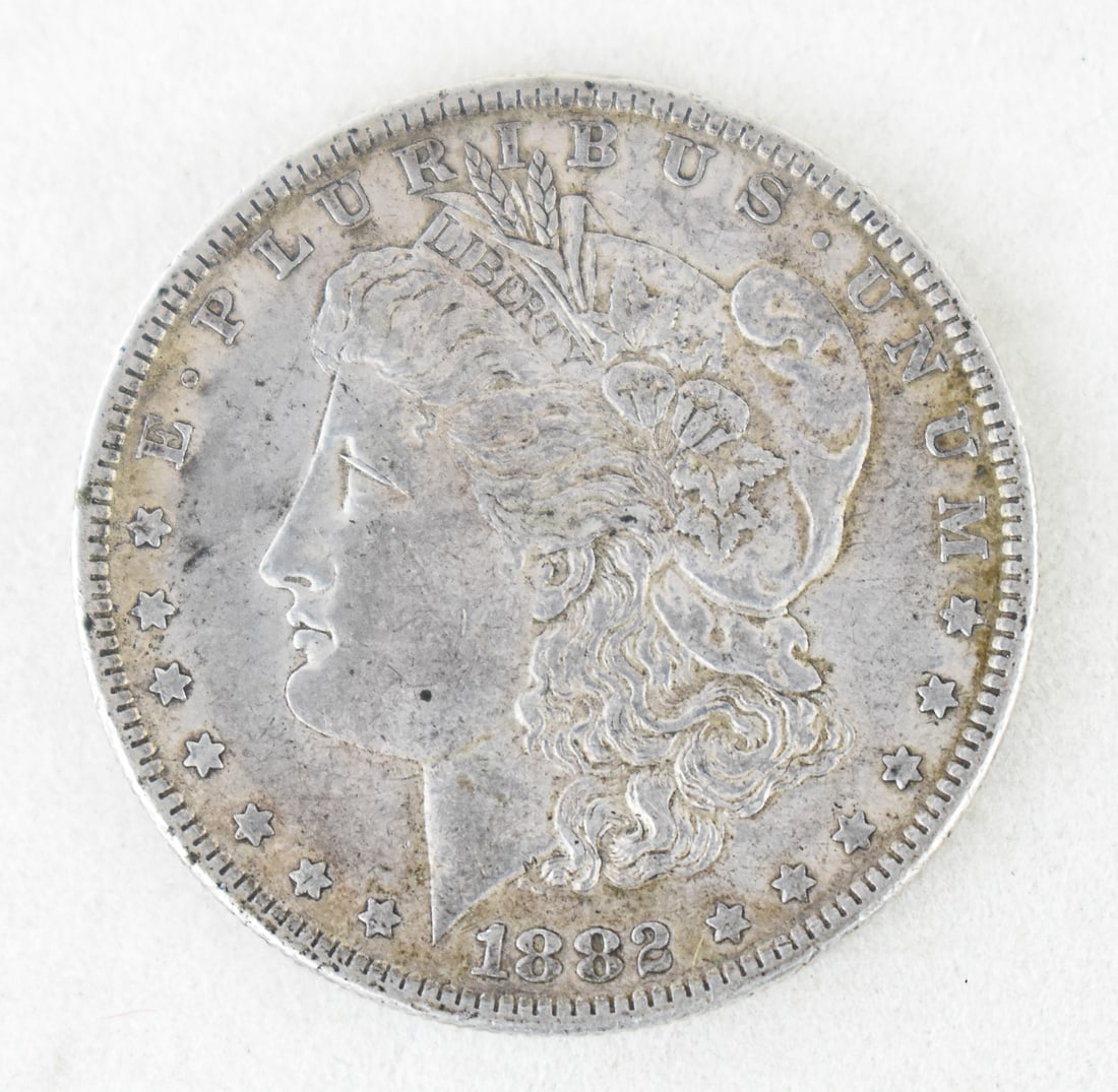 1882-O MORGAN SILVER DOLLAR: An 1882-O Morgan Silver Dollar minted in New Orleans, with a weight of 26.7 grams and struck in 90% silver.