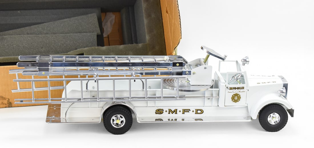 FRED THOMPSON SMITH-MILLER PRESSED STEEL No. 4 AERIAL LADDER FIRE ENGINE TRUCK W/ORIGINAL BOX: A limited edition Fred Thompson Smith-Miller pressed steel No. 4 aerial ladder fire engine truck with original box marked "L 095 175". The item measures 9.5" H, 29" W, 10.5" D.