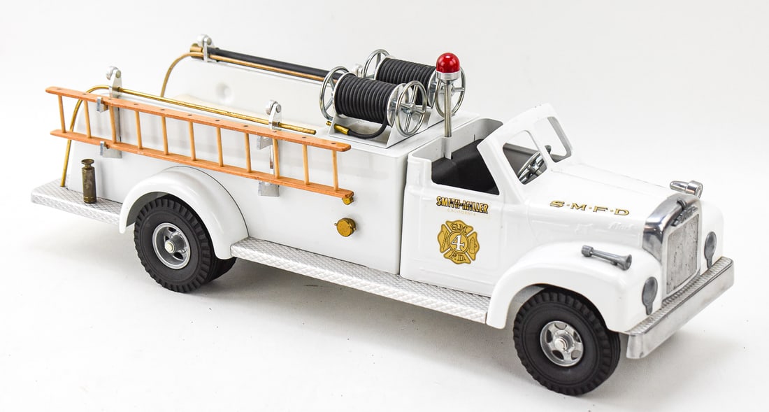FRED THOMPSON SMITH-MILLER LIMITED EDITION PRESSED STEEL No. 4 MACK FIRE ENGINE TRUCK: A limited edition Fred Thompson Smith-Miller pressed steel, aluminum, and brass No. 4 Mack fire engine truck marked "WP 093 115" and "SM 3007" with sealed new/old stock hose, circa 1980s. The item mea