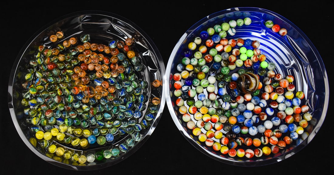 VINTAGE MARBLE COLLECTION, SOME URANIUM & CADMIUM/SELENIUM GLASS: A collection of over 350 vintage marbles mostly cat's eye marbles, including one shooter marble and one super jumbo sized marble. Six of the marbles are made with uranium glass and many other marbles 