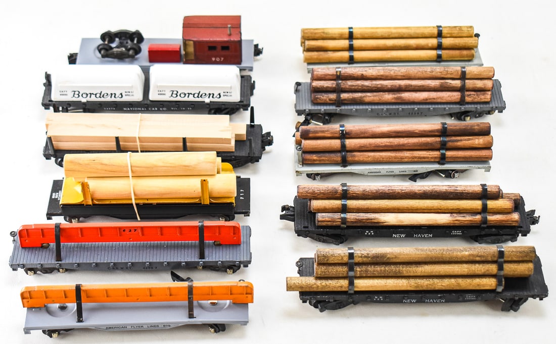 11 FLATCARS FROM AMERICAN FLYERS: Lot consists of eleven flatcars from the brand American Flyers. Of the eleven, one is made of steel, one of the 928 New Haven Log Car. Three of the cars have knuckle couples, while the remaining