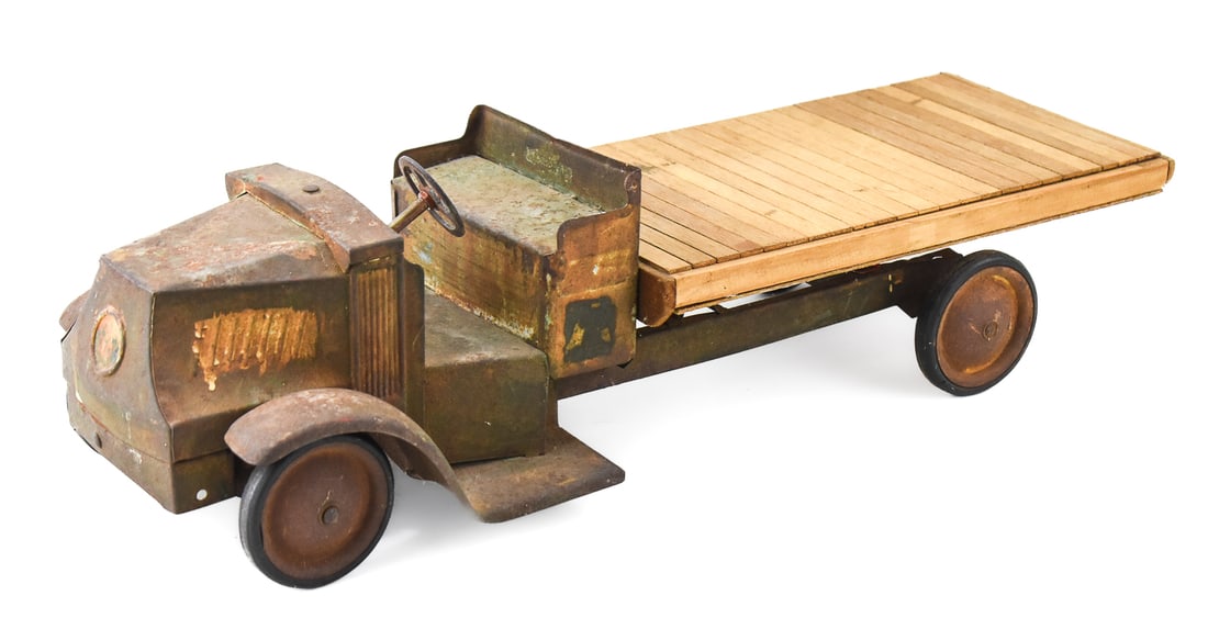 STEELCRAFT PRESSED STEEL MACK DUMP TRUCK: A Steelcraft pressed steel Mack dump truck with modern truck bed, circa early 20th century. The item measures 6.5" H, 8" W, 24.5" D.
