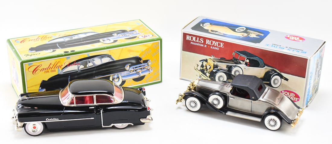 SOLID STATE ROLLS ROYCE PHANTOM II RADIO & 50'S CADILLAC SEDAN TIN TOY CAR: A Solid State Rolls Royce Phantom II transistor radio and a 50's brand Cadillac Sedan friction-powered tin toy car made in Japan. The radio in the box measures 4" H x 11.5" W x 5" D.