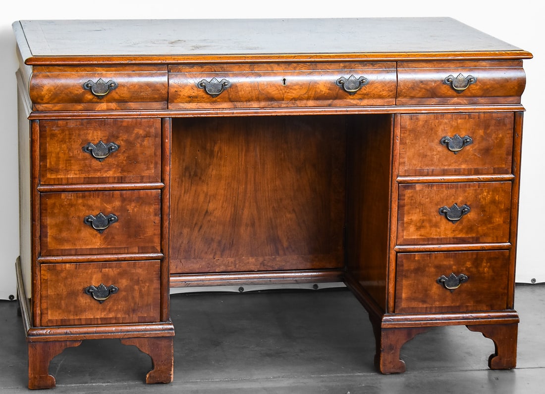 ANTIQUE MAHOGANY BURL PEDESTAL KNEEHOLE DESK: A antique mahogany burl pedestal kneehole desk with brass hardware. The desk measures 30" H x 45" W x 25" D.