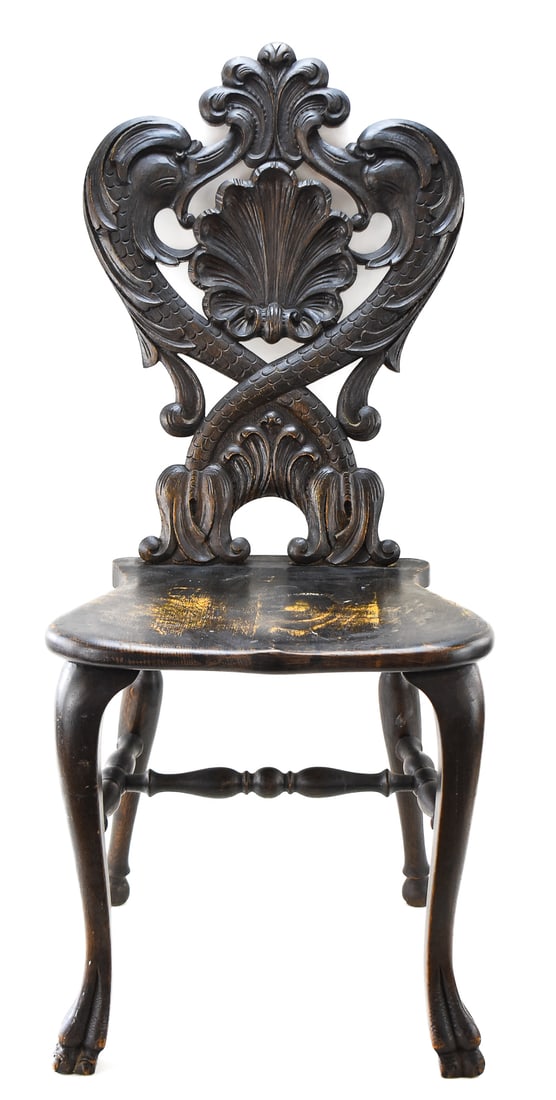 ORNATELY CARVED RENAISSANCE REVIVAL EBONIZED CLAW-FOOT CHAIR: A ornately carved circa late 1800s to early 1900s Renaissance Revival ebonized wood claw-foot chair also known as the "Dolphin" chair because of the mythical dolphin like carvings on the backrest.